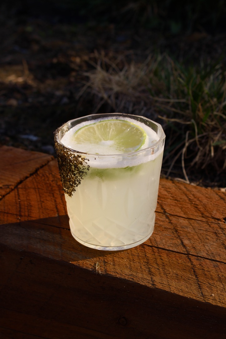 Lime cocktail with salted rim and fresh lime wheel