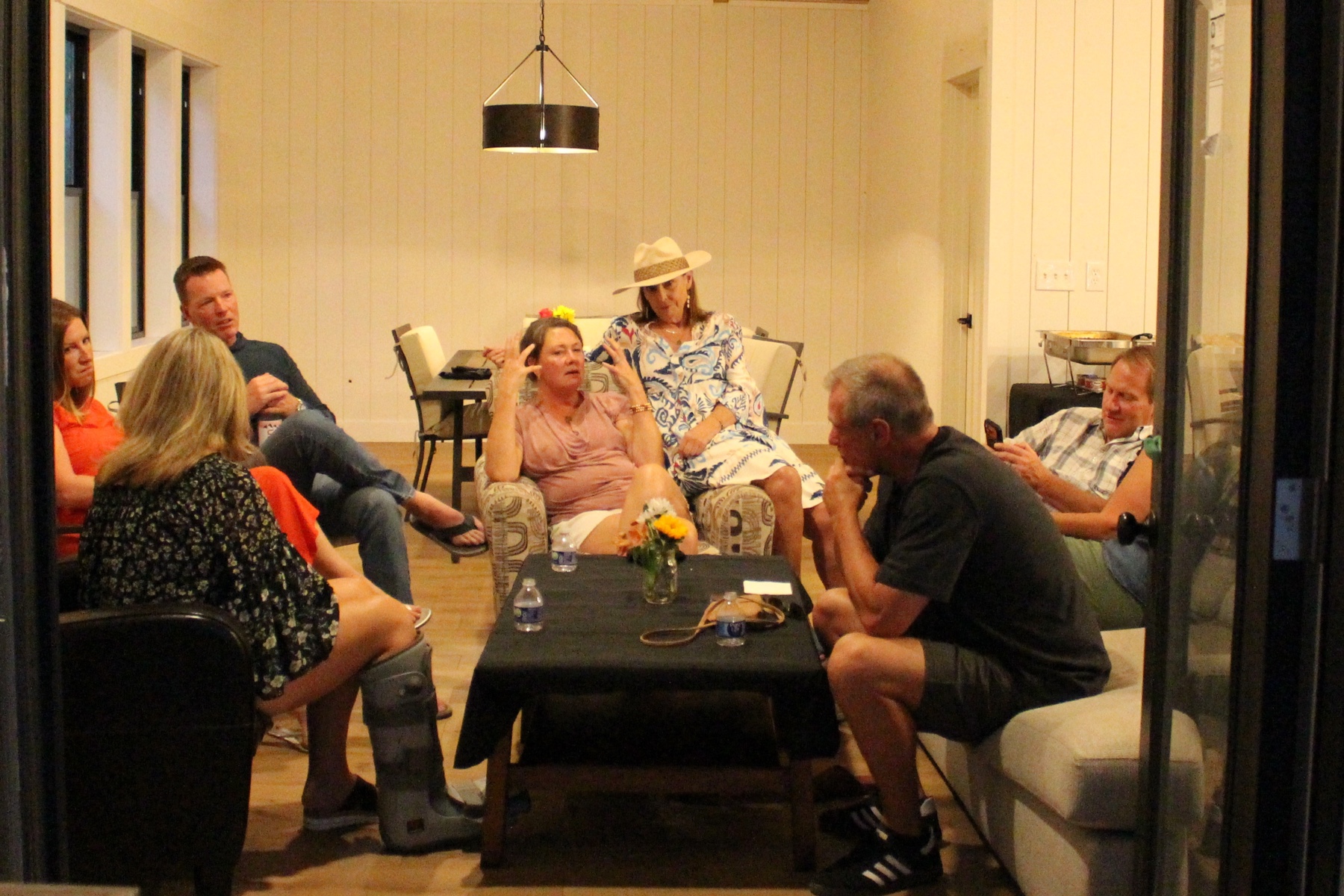 Guests relaxing and talking together in a living room at a private Bear n Bull celebration.